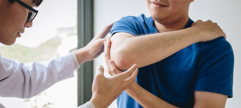 Doctor examining a patient's painful elbow. (c) UC Davis Regents. All rights reserved.