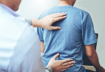 Doctor examining a patient's painful back. (c) UC Davis Regents. All rights reserved.