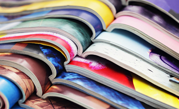 Stack of magazine publications. (c) UC Davis Regents. All rights reserved.