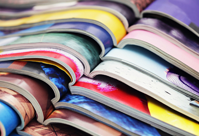 Stack of magazine publications (c) UC Davis Regents. All rights reserved.