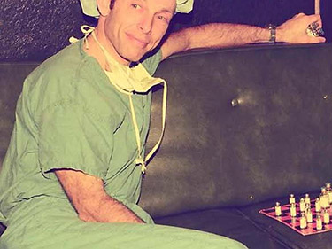 Dr. Eger in scrubs playing chess