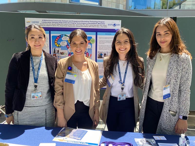 Office of Community Outreach and Engagement staff members standing at a table