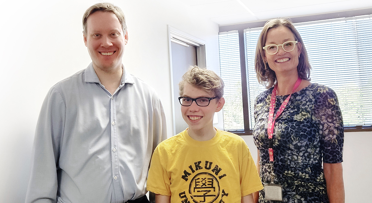 Pediatric neurology patient James with his neurosurgeons