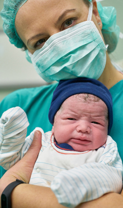 Nurse holding a baby. (c) All rights reserved.