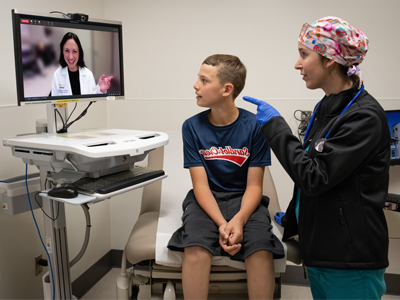 Nurse and pediatric patient in a video visit with a clinician (c) UC Regents. All rights reserved.
