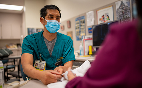 UC Davis Health nurse assisting patient