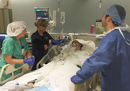 Mrs. Box arrives in the recovery room. One of her anesthesiologists, Seth Lerner, monitors her as she wakes up.