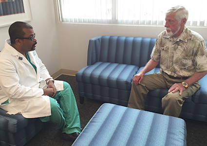 Dr. Cooke delivers the good news to Mrs. Box’s husband, Dan, that the surgery went well.