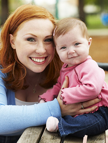 A Sacramento area mother smiles with her infant daughter, who had three open-heart surgeries at UC Davis Children’s Hospital. &#169; UC Regents