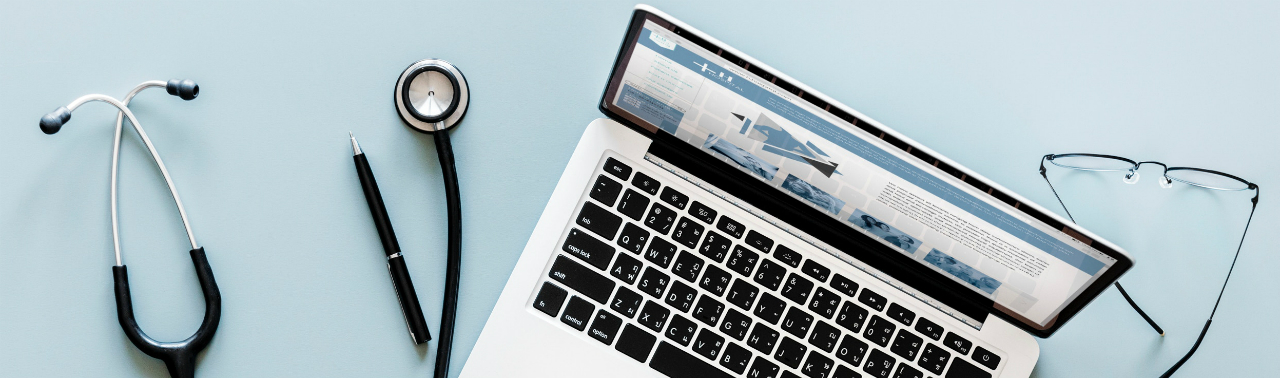 Picture of a computer and stethascope and glasses.  Looking like someone is studying