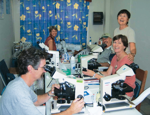 Theresa Loya (M.D. ’76, standing) with fellow volunteers during a cervical cancer screening and treatment mission to Belize.