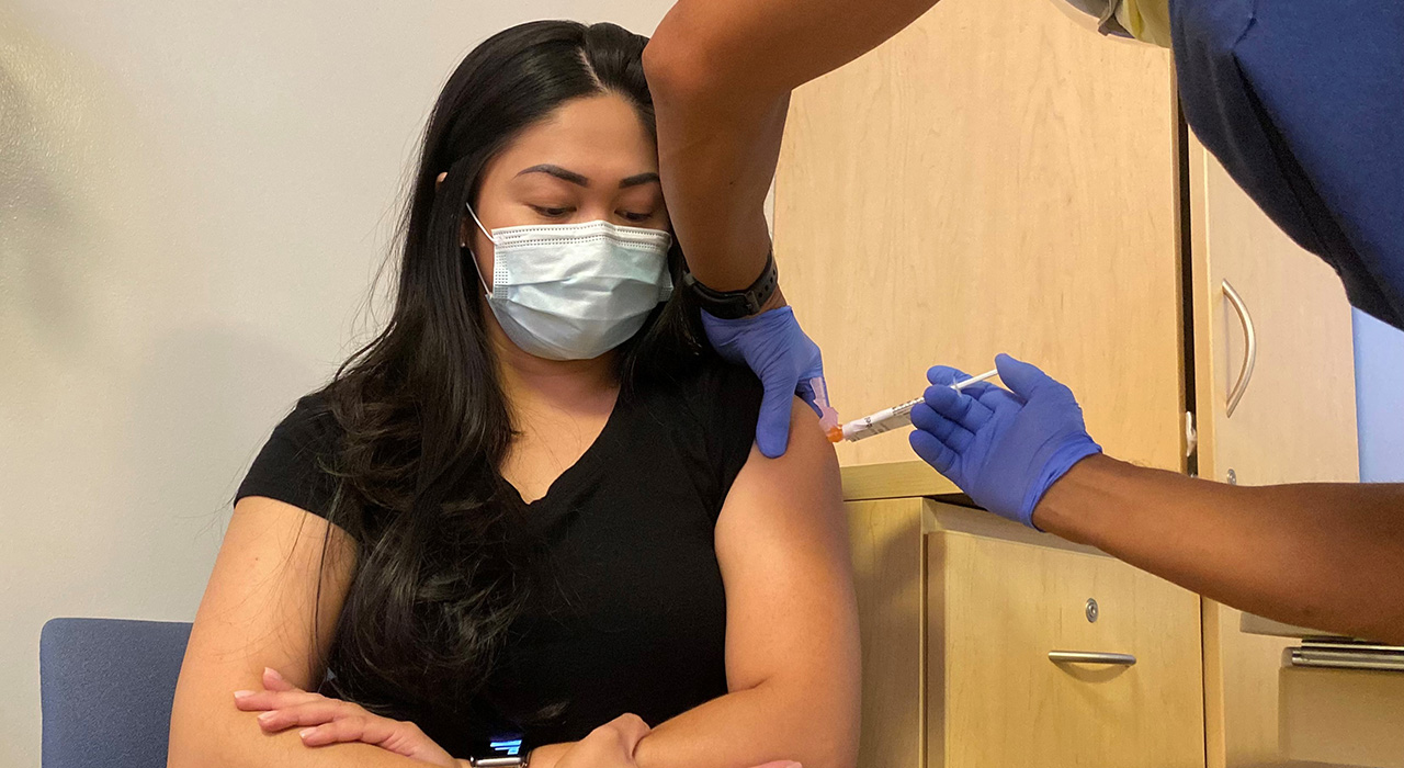 Clinical trial participant Nicholeth Santiago receives either a Pfizer booster vaccine or placebo this summer at UC Davis Health.