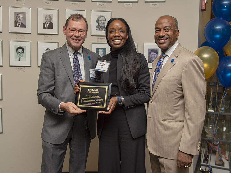 Nadine Burke Harris (M.D., ’01), California’s first-ever surgeon general, receives the School of Medicine Alumni Association’s Transformational Leadership Award from UC Davis Chancellor Gary S. May and School of Medicine Interim Dean Lars Berglund.