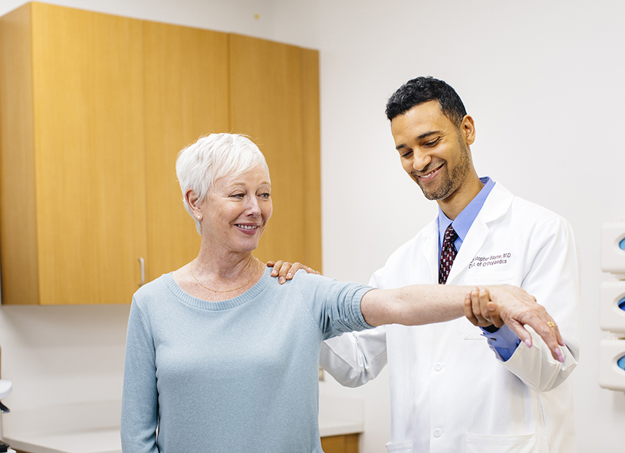 Orthopaedic hand specialist Christopher Bayne, M.D., and patient