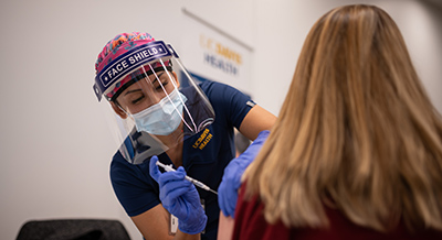 Nurse giving a patient a vaccine shot