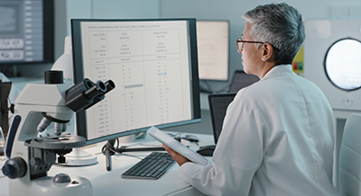 Doctor reading data at a computer