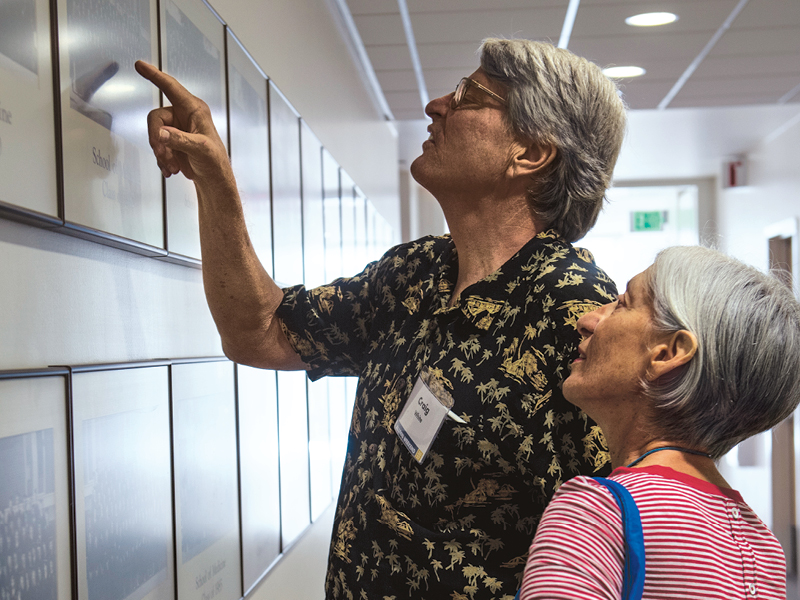 Hunting for old class photos on the Education Building’s display walls.