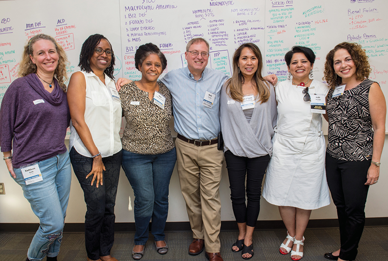 Members of the Class of 1992 at their reunion class catch-up in an Education Building classroom.