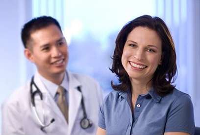 Female patient smiling in front of male patient. @UC Regents. All rights reserved.