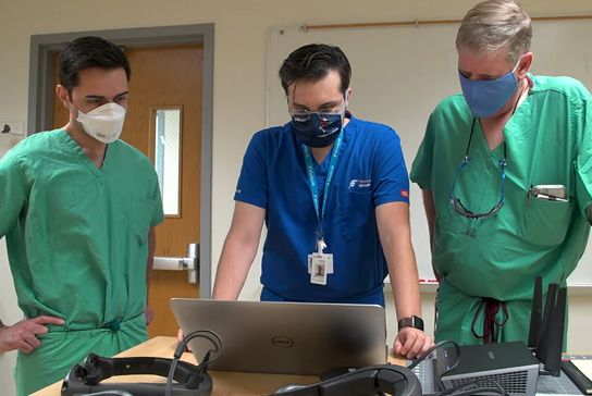 Surgeons using computer data to produce 3D surgery visualization.