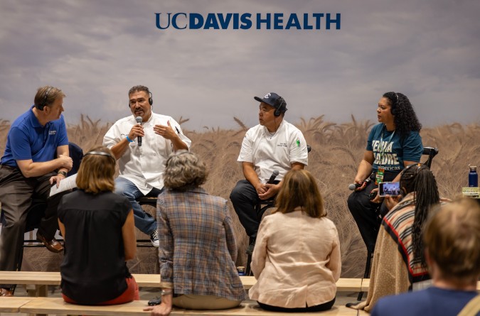 Four people speaking at a panel session