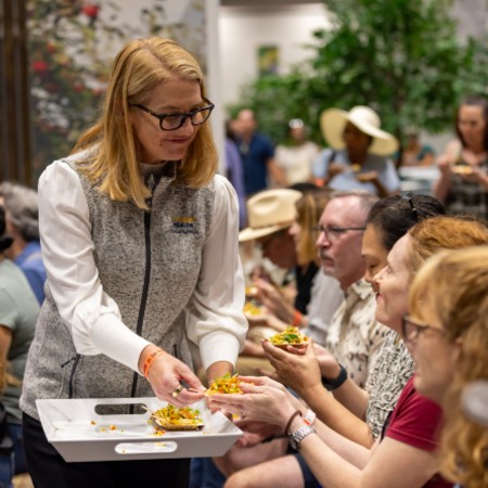 A woman handing out food samples