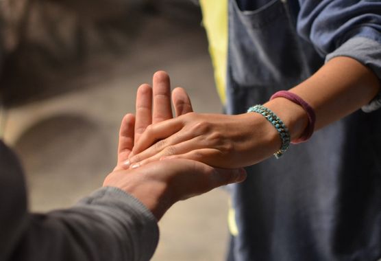 multiple hands stacked on top of one another