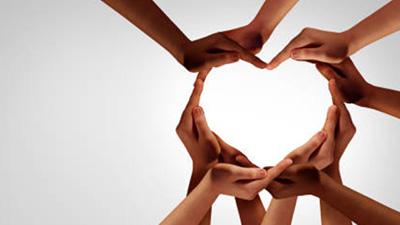 Hands embracing painted heart rock, stock