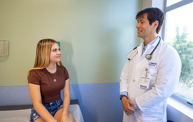 Adolescent female patient being examined by adolescent medicine physician