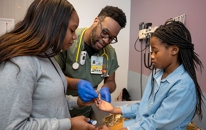 UC Davis medical assistant with mom and diabetic patient in a medical office