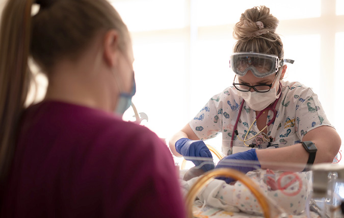 Nurse with newborn in NICU