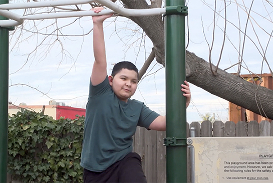 Damian playing on monkey bars