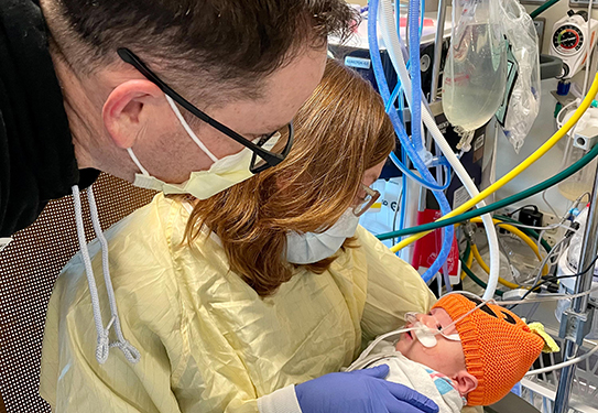 Ellie Hipwell being held by her parents