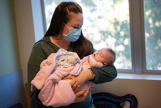 Tabitha being held by her mother