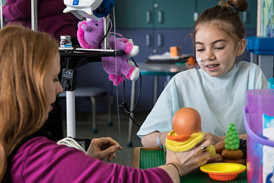 Child life specialist with patient