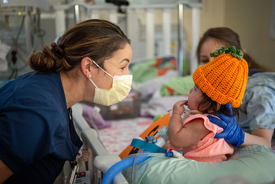 NICU nurse checking on preemie