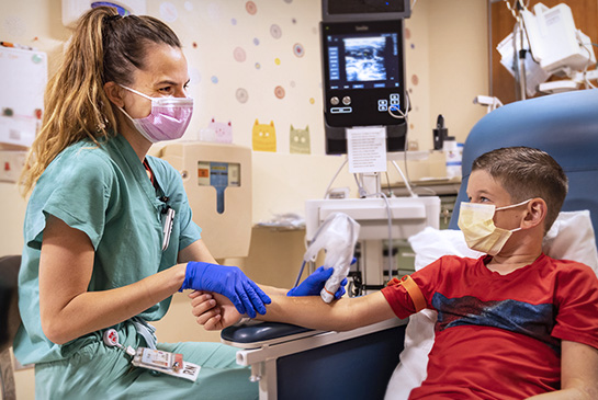 Registered nurse checking vitals of young male patient