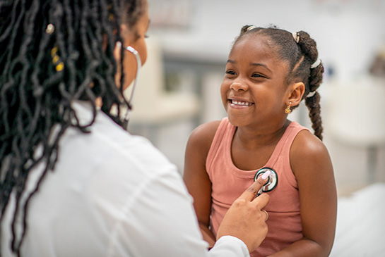 Young patient getting check-up from pediatrician