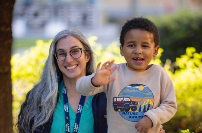 little boy smiling with a female doctor
