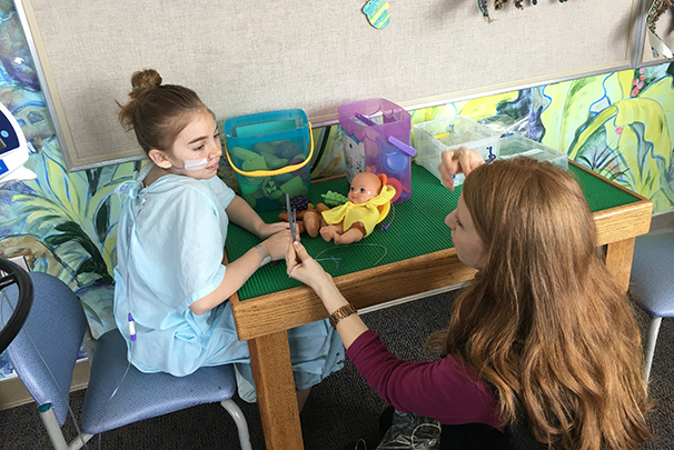 Child patient playing with health care worker