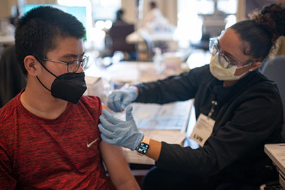 Young girl receiving a vaccination from a healthcare worker.