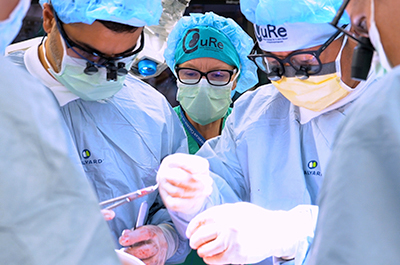 An operating room with surgeons working on a patient.