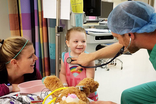 Health care workers talking with child patient