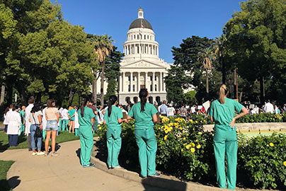 Circle Clinic Values, Community, medical staff gather in front of Sacramento Capitol