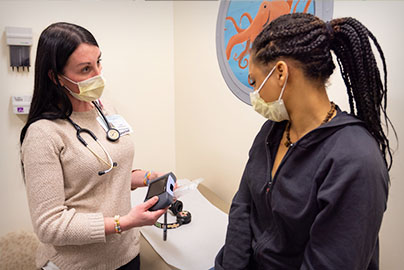 Pediatric sickle cell clinic, patient with care team member