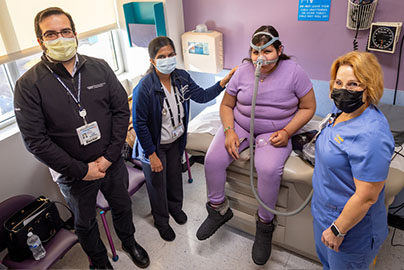 Sleep lab team with young patient in a clinical setting