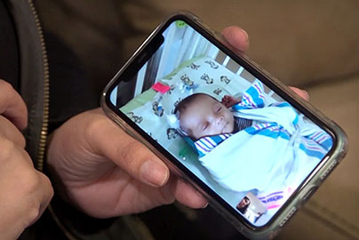 Mom viewing NICU baby on phone