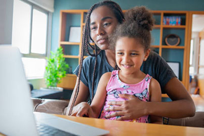 Mom with child at computer at home