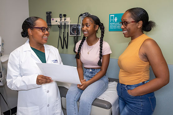 Adolescent teen female and mother in clinical office for a consultation with Adolescent Medicine physician