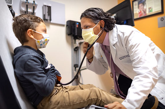 Pediatrician Fernandez y Garcia with patient